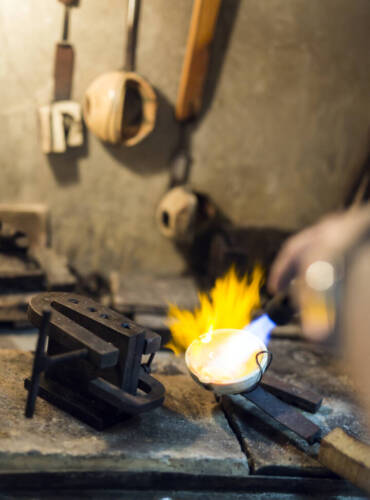 Jeweler melting gold, metal and making jewelry